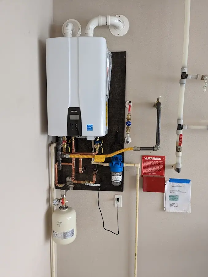 Professional plumber installing copper piping in a Middlebury home